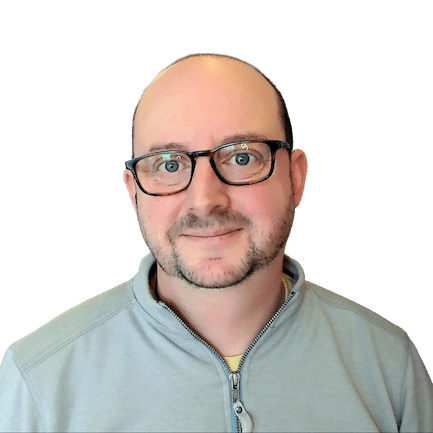 Corey Maass smiling with glasses on